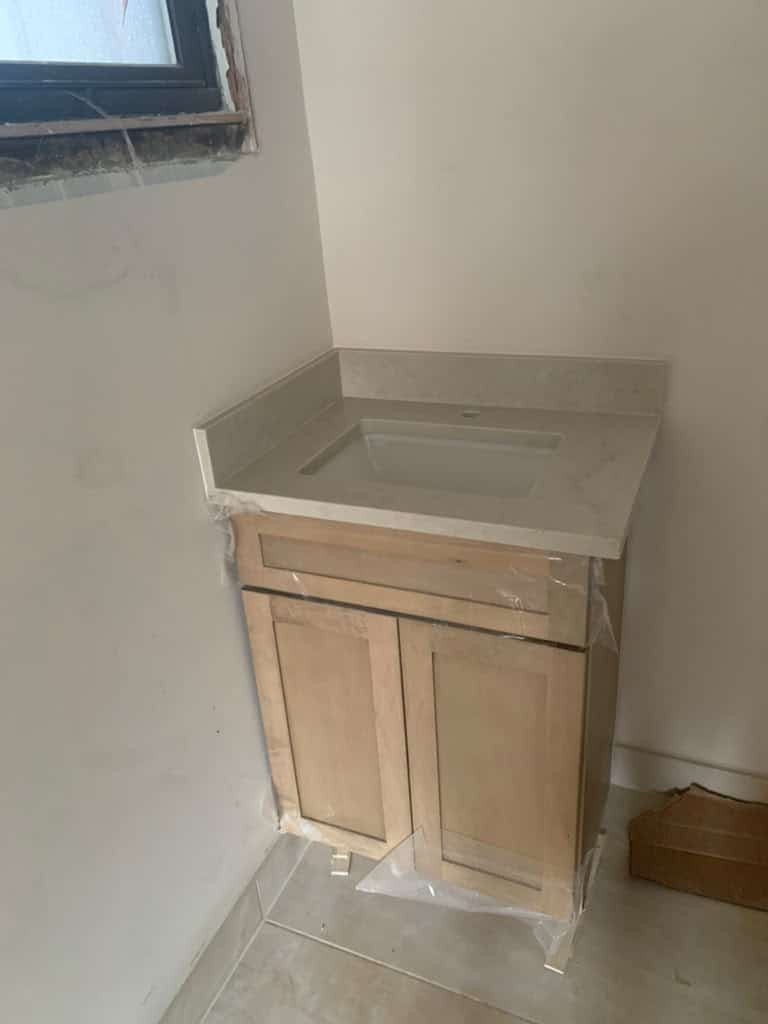 Grey veined quartz bathroom vanity countertop with an integrated backsplash and undermount sink