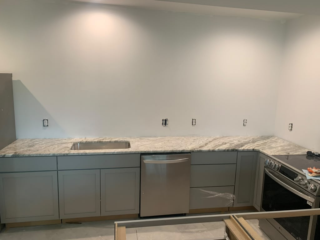 Brown Fantasy granite countertops with grey cabinets in South Gate, Michigan