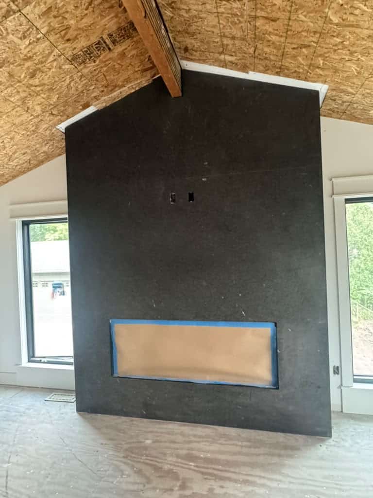 Custom black stone fireplace surround with opening for fireplace insert